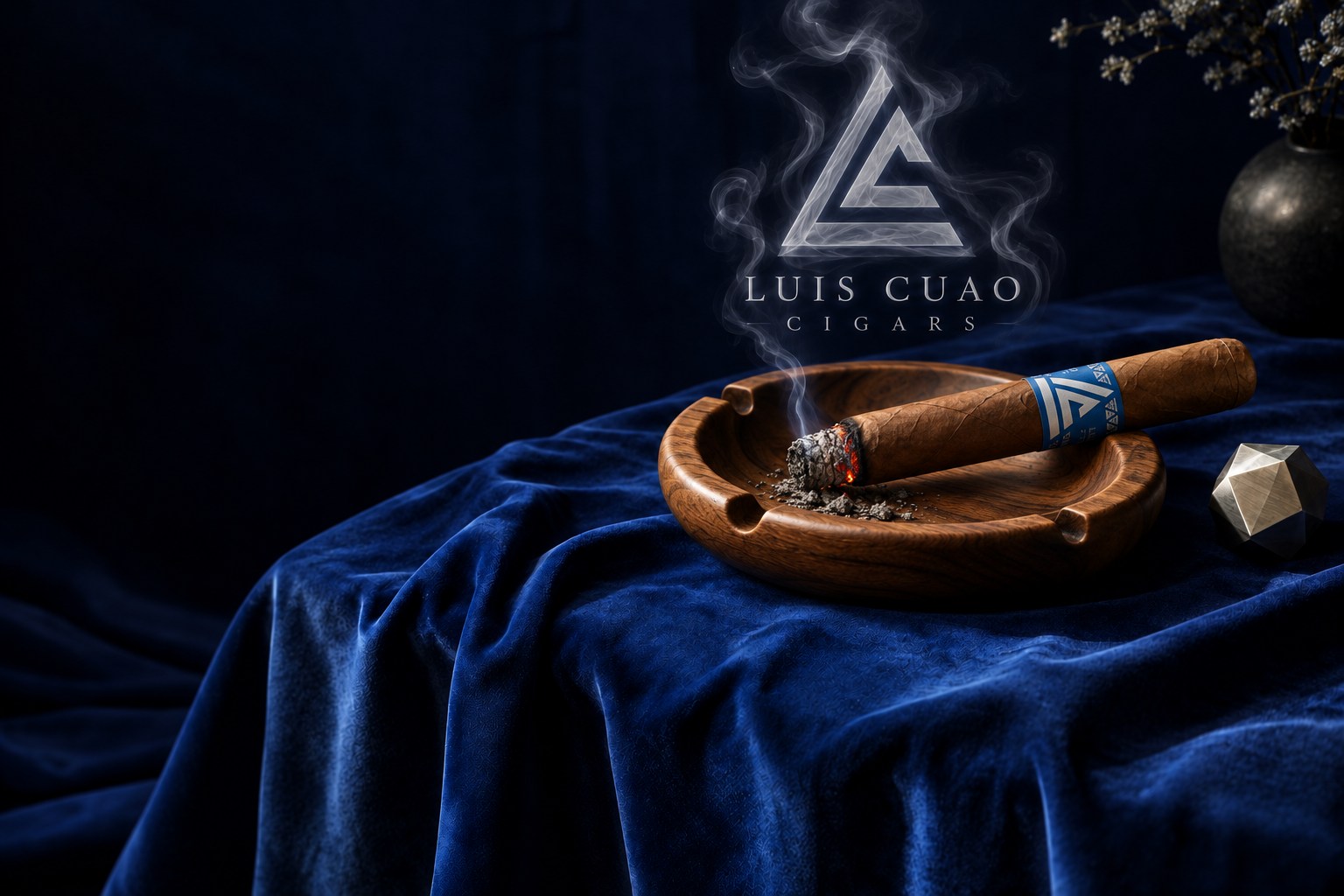 A lit LC cigar rests in a wooden ashtray, its smoke rising into the triangular LC logo over navy velvet.